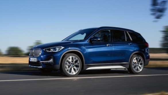 Plug-in хибрид BMW X1 xDrive25e F48 LCI тричетвртински страничен поглед во возење Plug-in хибрид BMW X1 xDrive25e F48 LCI тричетвртински страничен поглед во возење на улица