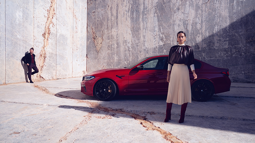 BMW M5 Competition F90 LCI Facelift 2020 side view with woman BMW M5 Competition F90 LCI Facelift 2020 BMW Individual Imola Red side view with woman