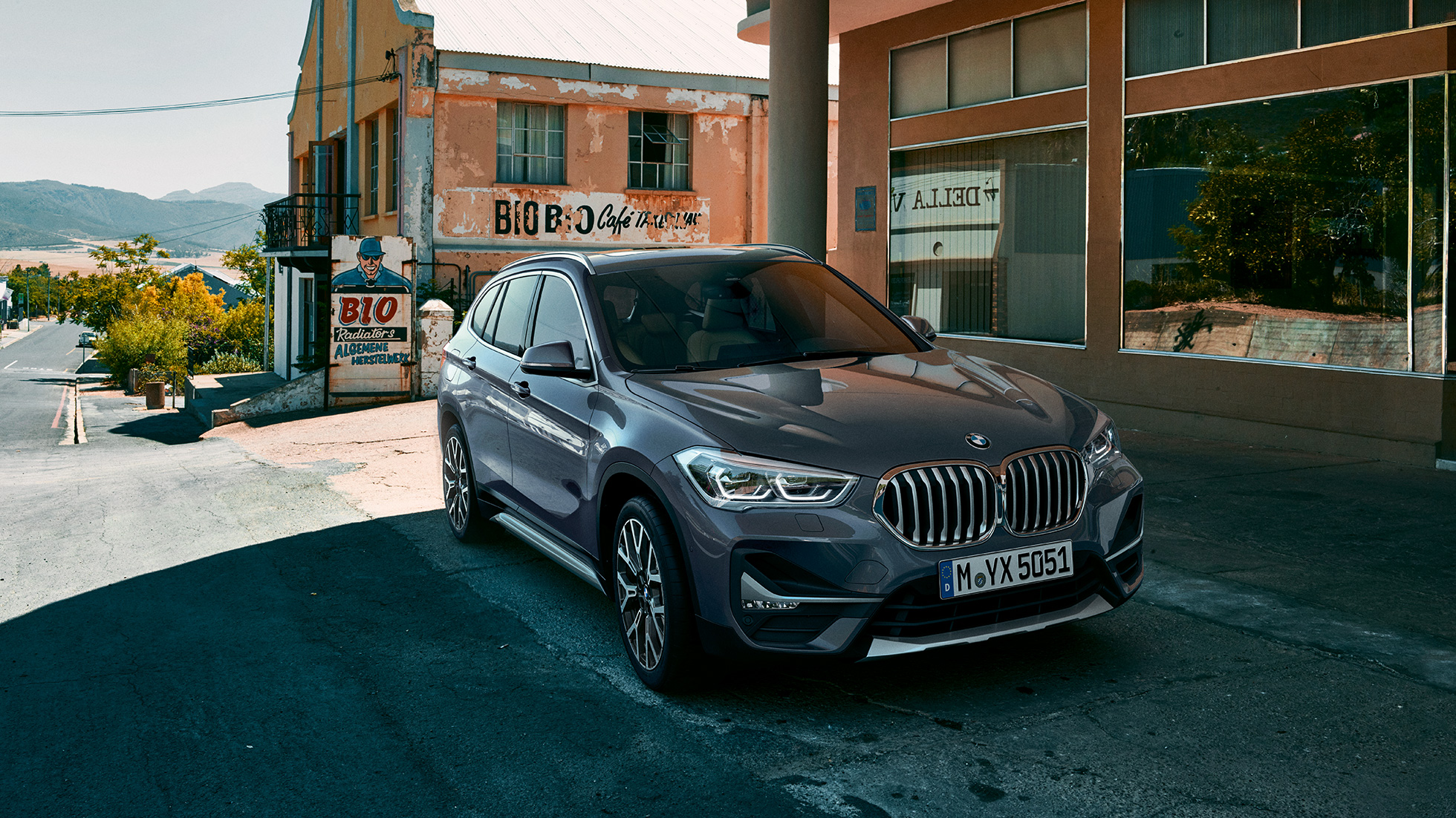 BMW X1, тричетвртински приказ од напред. BMW X1, тричетвртински приказ од напред, паркиран пред урбана заднина