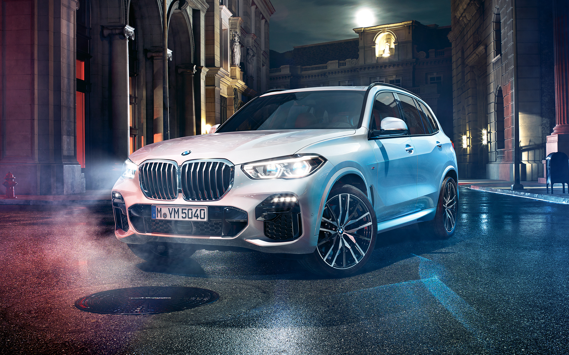 Преден кадар на BMW X5 ноќе во урбана средина